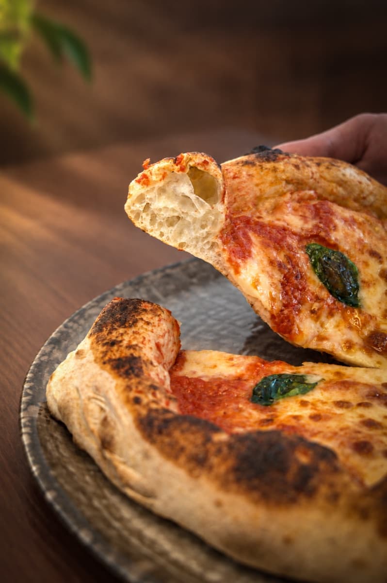 A slice lifted from the plate, showing the airy crust
